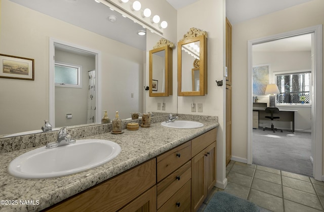 full bathroom with double vanity, tile patterned flooring, baseboards, and a sink