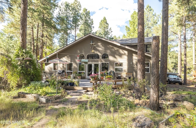 back of property with french doors and a deck