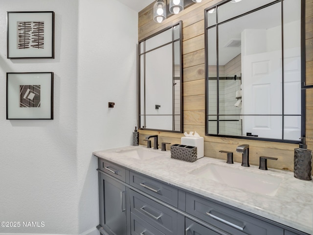 6136 E Abineau Canyon Dr, Flagstaff, AZ 86004 - bathroom featuring double vanity and wooden walls