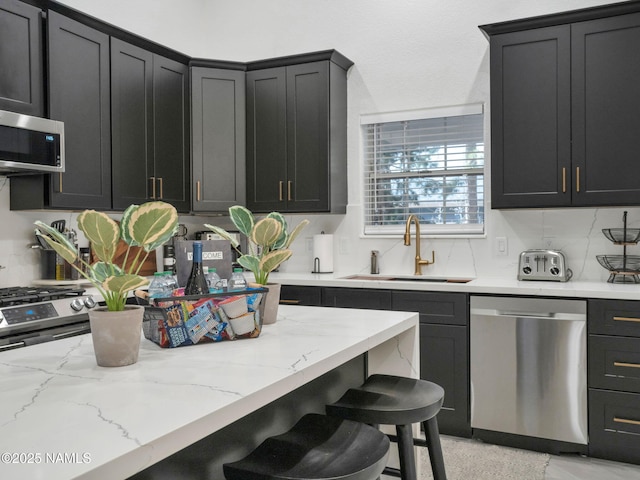 6136 E Abineau Canyon Dr, Flagstaff, AZ 86004 - kitchen featuring appliances with stainless steel finishes, a sink, and dark cabinetry