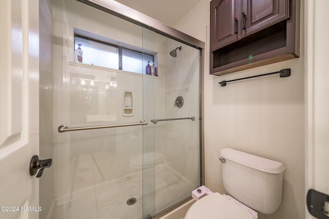 bathroom with toilet and walk in shower