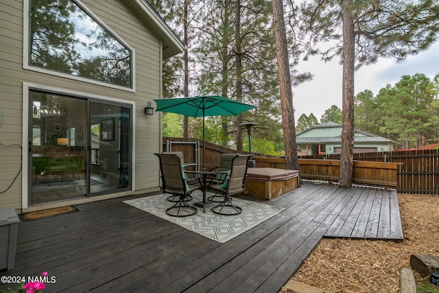 wooden terrace with a covered hot tub