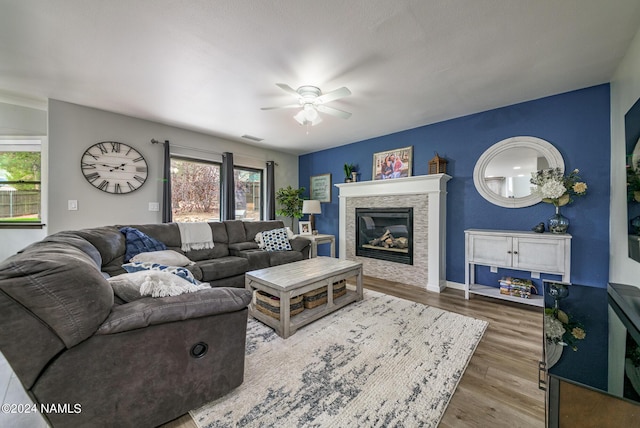 living room featuring ceiling fan and dark hardwood / wood-style flooring