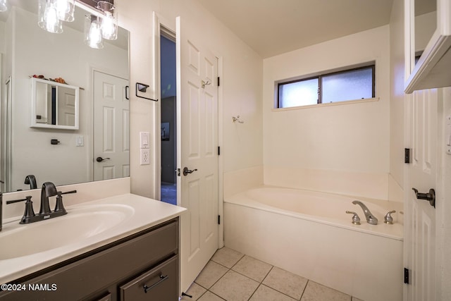 bathroom featuring vanity, a bathtub, and tile patterned floors