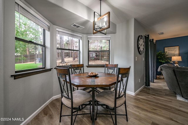 dining area featuring hardwood / wood-style flooring and a healthy amount of sunlight