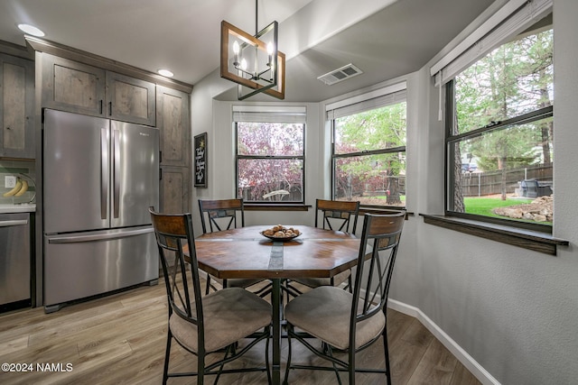 dining area with plenty of natural light and light wood-type flooring