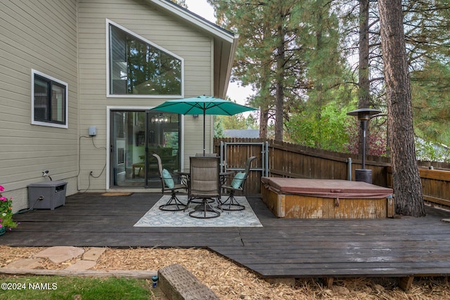 wooden deck featuring a covered hot tub