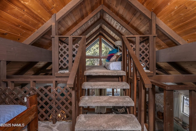 interior space featuring wood ceiling, lofted ceiling with beams, and carpet floors