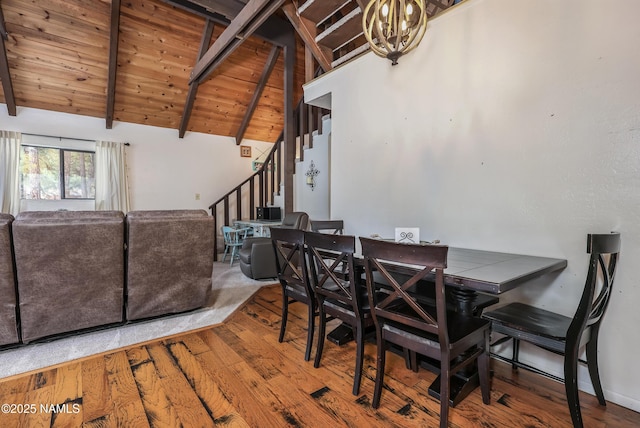 dining space featuring wooden ceiling, beamed ceiling, a chandelier, and stairs