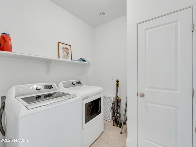 laundry area featuring laundry area, light tile patterned floors, visible vents, and washer and dryer