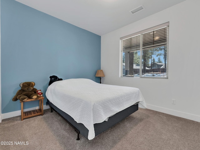 bedroom with carpet floors, visible vents, and baseboards