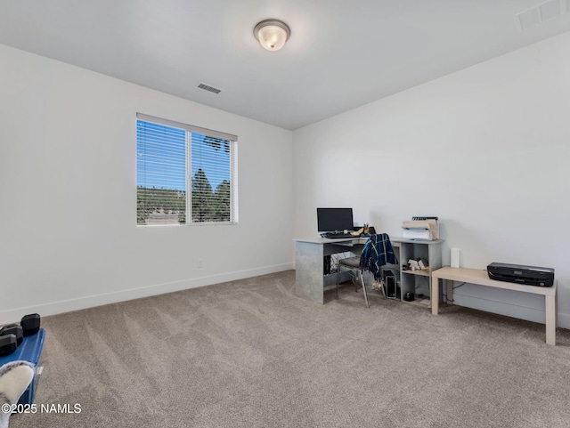 carpeted home office with visible vents and baseboards