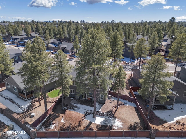 drone / aerial view with a residential view and a wooded view