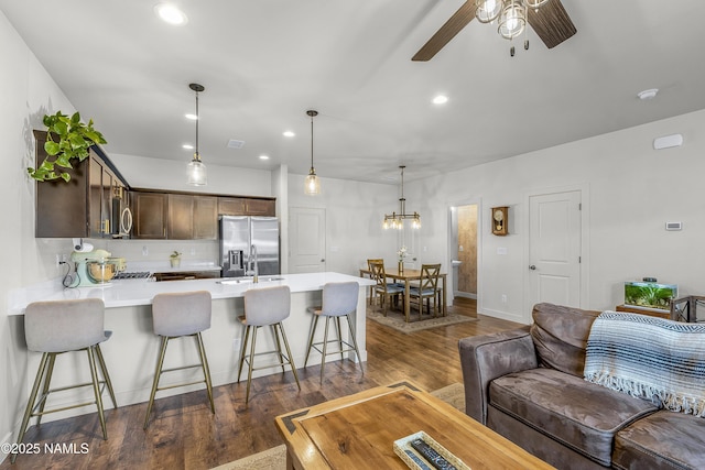 12296 Curtis Ct, Bellemont, AZ 86015 - living room with ceiling fan, dark wood-style floors, recessed lighting, and a chandelier