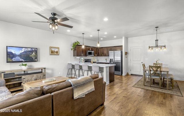 12296 Curtis Ct, Bellemont, AZ 86015 - living area with a chandelier, wood finished floors, ceiling fan, and recessed lighting