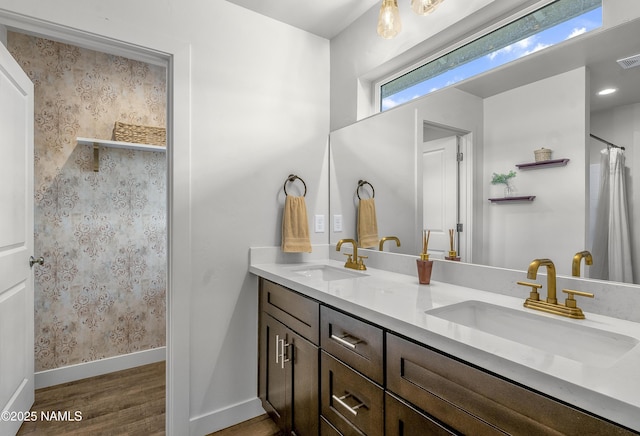 12296 Curtis Ct, Bellemont, AZ 86015 - bathroom with wood finished floors, double vanity, and curtained shower
