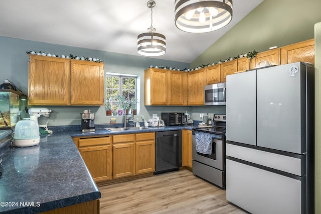 kitchen featuring high vaulted ceiling, sink, appliances with stainless steel finishes, and light hardwood / wood-style flooring