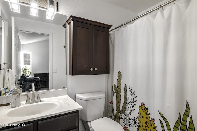 bathroom featuring toilet and vanity