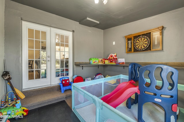 game room featuring french doors and carpet flooring