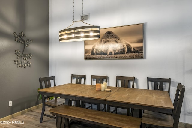 dining space with hardwood / wood-style flooring