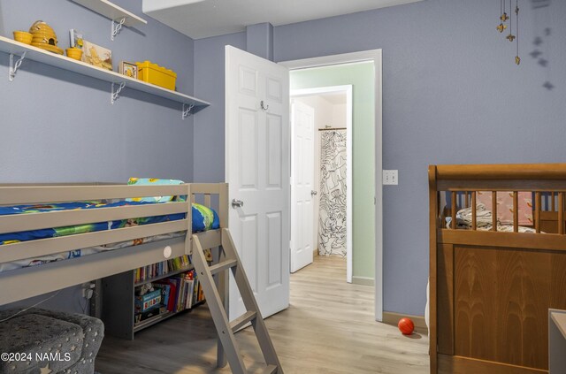 bedroom with hardwood / wood-style flooring