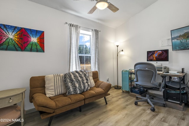 office area with light hardwood / wood-style floors, vaulted ceiling, and ceiling fan