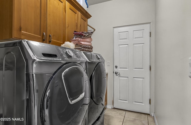 11267 N Lilac Ln, Flagstaff, AZ 86004 - laundry room with washing machine and dryer, cabinet space, light tile patterned floors, and baseboards