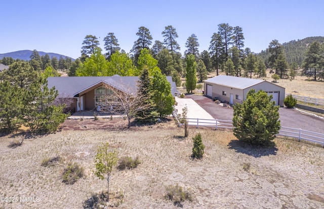 11267 N Lilac Ln, Flagstaff, AZ 86004 - view of front of house with a detached garage, a mountain view, metal roof, and an outbuilding