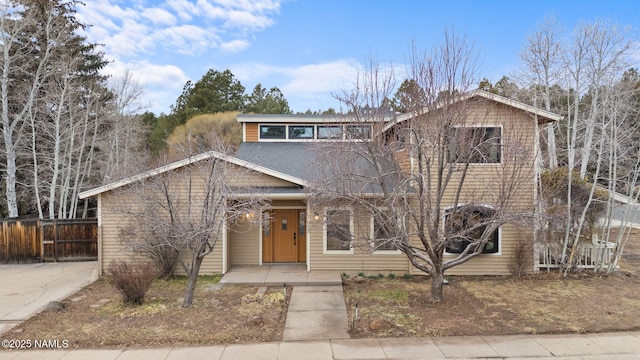 view of front of house featuring fence