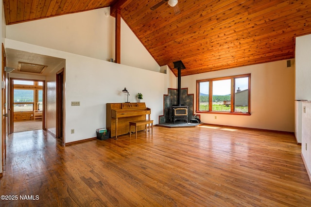6600 W Suzette Ln, Flagstaff, AZ 86001 - living room with a wood stove, high vaulted ceiling, wood finished floors, plenty of natural light, and wood ceiling