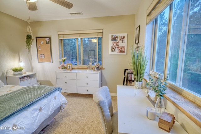 bedroom featuring light colored carpet and ceiling fan