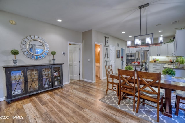 dining space featuring light hardwood / wood-style floors