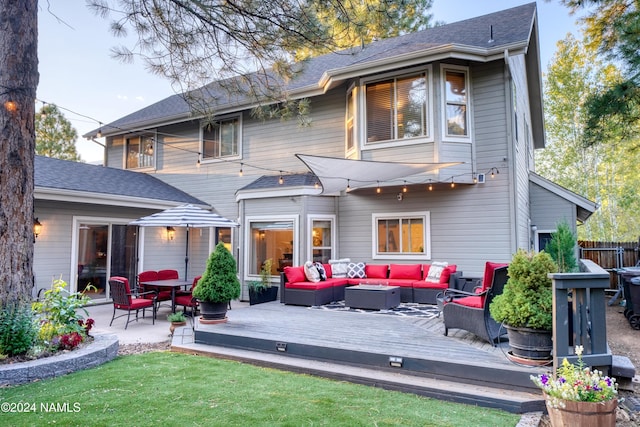 rear view of house with outdoor lounge area and a wooden deck