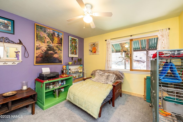 carpeted bedroom with baseboards and ceiling fan