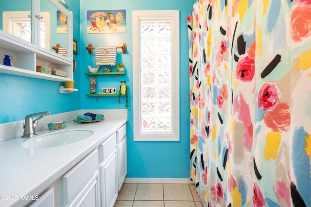 bathroom with vanity, tile patterned floors, a shower with curtain, and baseboards
