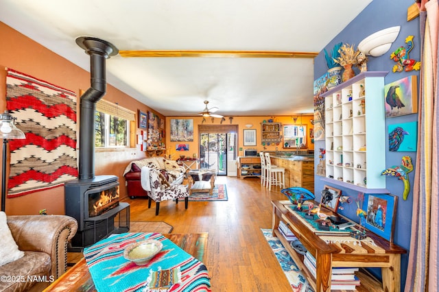 living room featuring hardwood / wood-style floors and a wood stove