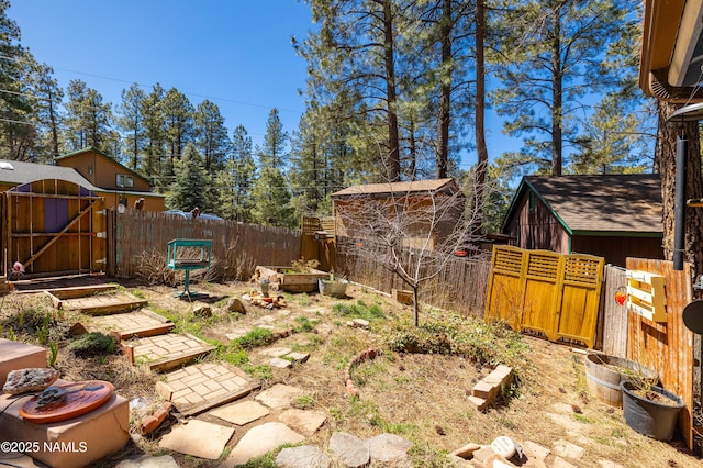 view of yard featuring a garden, fence, and a gate