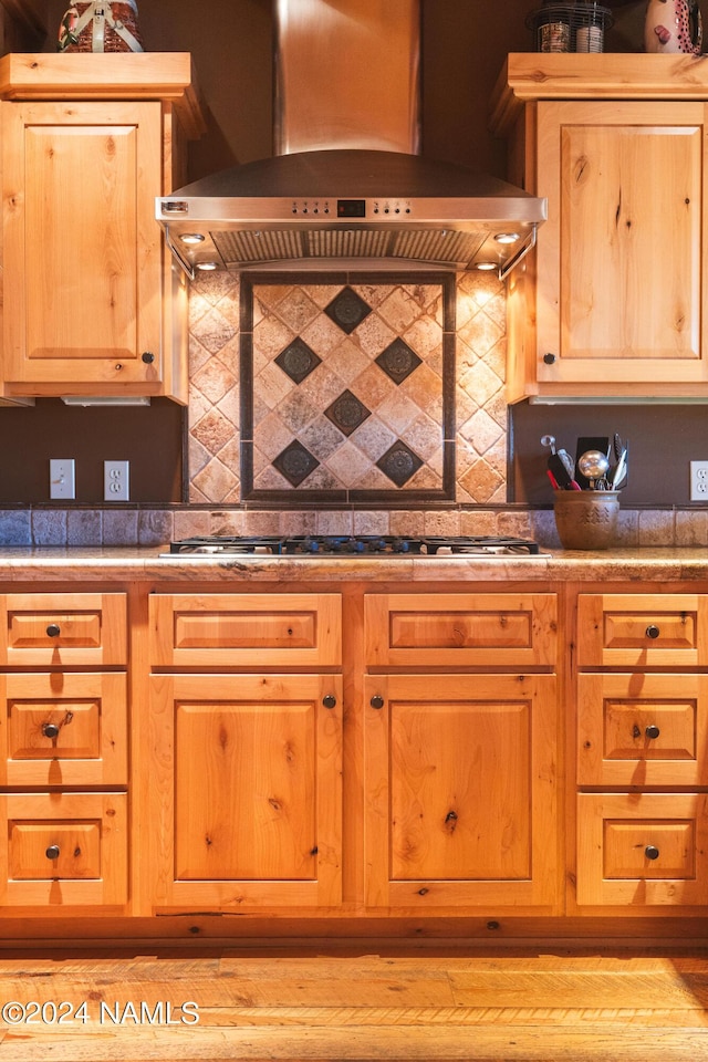 12696 Rustic Cabin Trl, Parks, AZ 86018 - kitchen featuring range hood, stainless steel gas stovetop, and tasteful backsplash