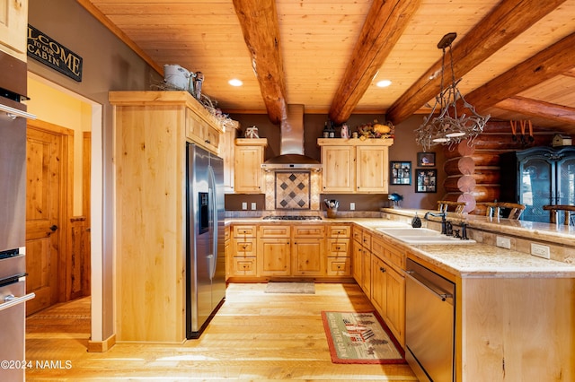 kitchen featuring beamed ceiling, log walls, appliances with stainless steel finishes, wall chimney range hood, and decorative light fixtures