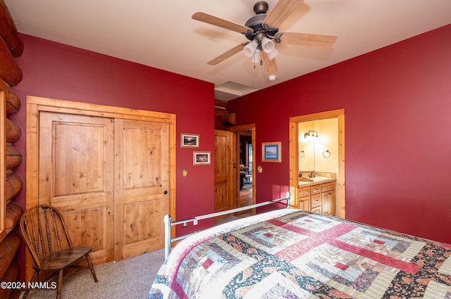 bedroom featuring sink, ceiling fan, ensuite bathroom, and carpet floors