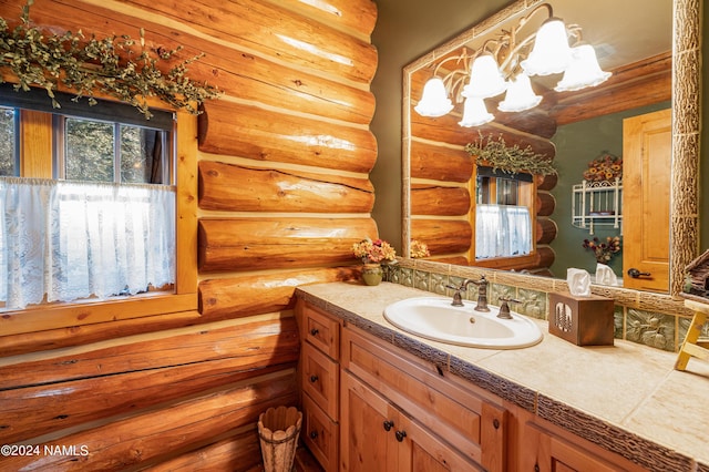 bathroom with vanity and log walls