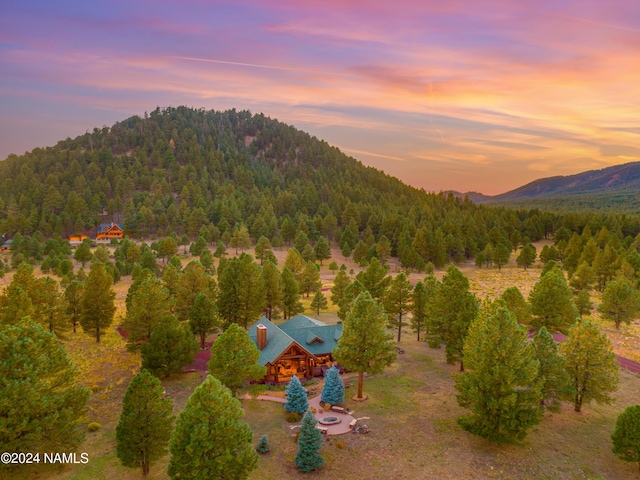 aerial view at dusk featuring a mountain view