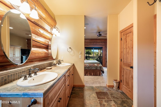 bathroom with ceiling fan, vanity, and tasteful backsplash