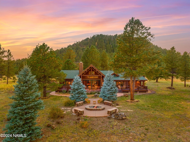 yard at dusk featuring a fire pit