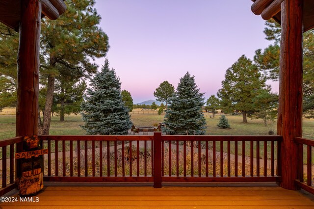 12696 Rustic Cabin Trl, Parks, AZ 86018 - deck at dusk with a rural view