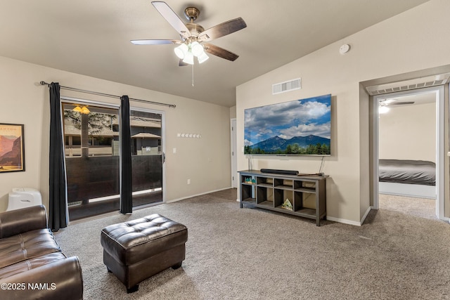 living room with ceiling fan, carpet flooring, vaulted ceiling, and baseboards