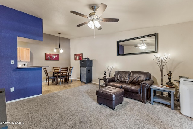 living room with a ceiling fan, carpet flooring, and baseboards