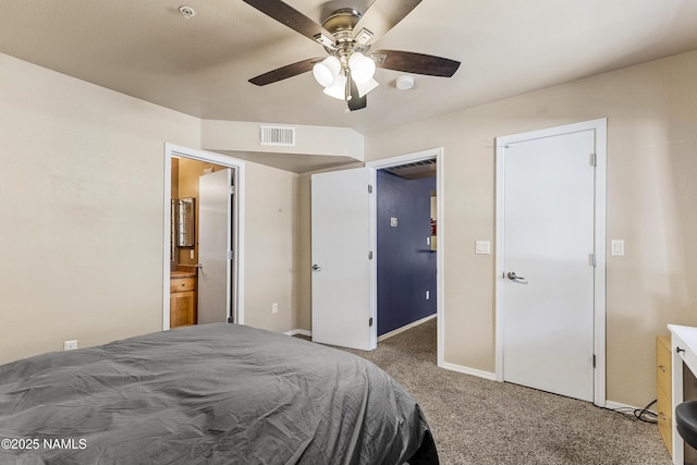 carpeted bedroom featuring baseboards, connected bathroom, and a ceiling fan