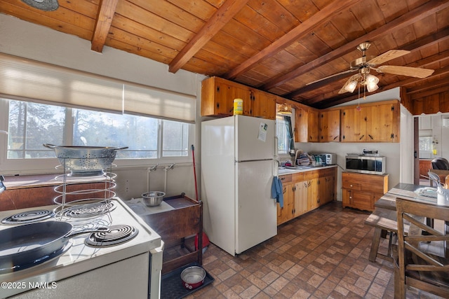 kitchen with brick patterned floor, lofted ceiling with beams, wooden ceiling, and white appliances