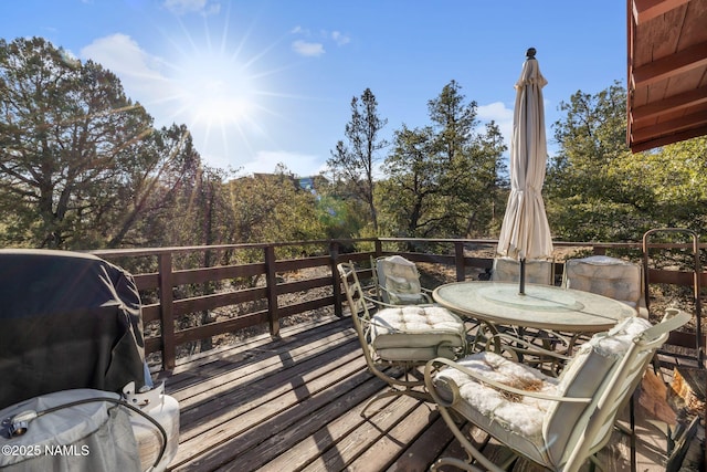 deck featuring outdoor dining area and area for grilling